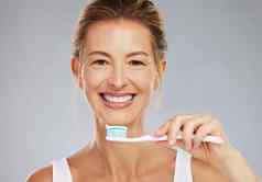 高级女人肖像牙刷牙科治疗牙齿美白灰色工作室成熟的健康的快乐夫人牙膏口清洁白色微笑脸模型