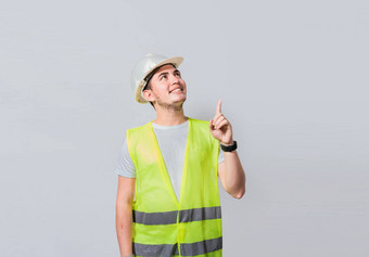构建器工程师指出手指孤立的肖像工程师男人。指出建设工程师背心指出广告工程师男人。指出一边