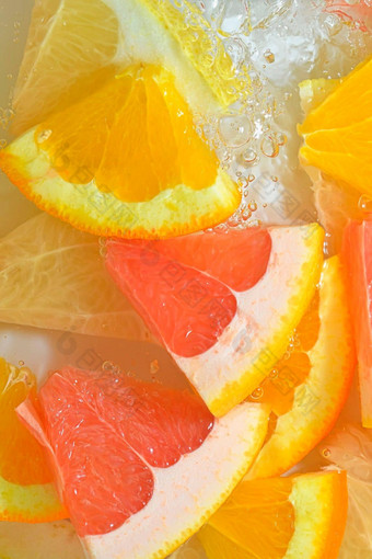 新鲜的片葡萄柚橙色水果蜂蜜葡萄柚白色背景块葡萄柚橙色水果蜂蜜葡萄柚闪闪发光的水白色背景特写镜头垂直宏图像前视图平设计夏天水果背景