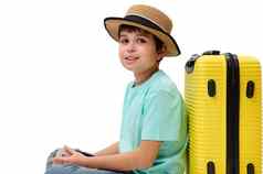 十几岁的男孩蓝色的t恤稻草他手提箱登机通过相机孤立的白色背景