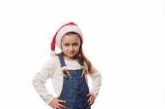 可爱的孩子女孩穿圣诞老人他摆姿势糖果拐杖口袋里牛仔布工作服白色背景