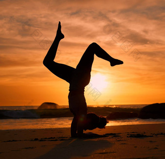 瑜伽轮廓倒立日落海滩海洋海晚上锻炼放松锻炼培训瑜珈女人沙子平衡构成日出医疗保健健康健身强大的身体