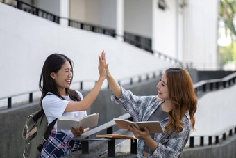 快乐的亚洲大学女<strong>学生会</strong>说话的分享的想法工作学校项目