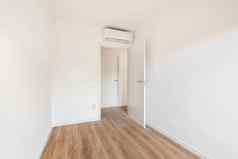 视图前面通过小白色有空调的房间木地板上酒店概念简单的改造空公寓移动