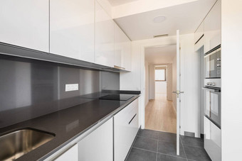 现代高科技厨房黑色的白色现代电器家具开放通过俯瞰走廊小房间窗口阳光明媚的夏天一天概念舒适的公寓