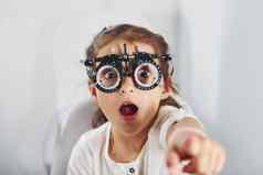可爱的女孩眼科学诊所特殊的工具眼睛测试