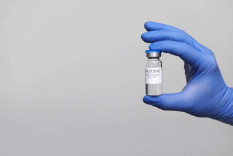 发展创建冠状病毒疫苗科维德冠状病毒疫苗玻璃瓶手医生灰色的背景疫苗概念战斗冠状病毒