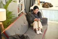 满意亚洲女人聊天在线阅读消息移动电话放松生活房间