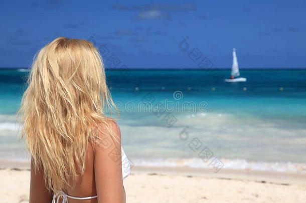 穿着比基尼的女人在海滩上排队