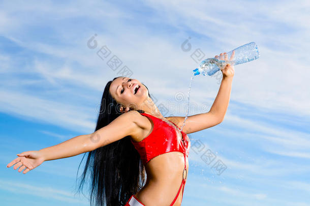 穿红色制服拿着一瓶水的运动女郎