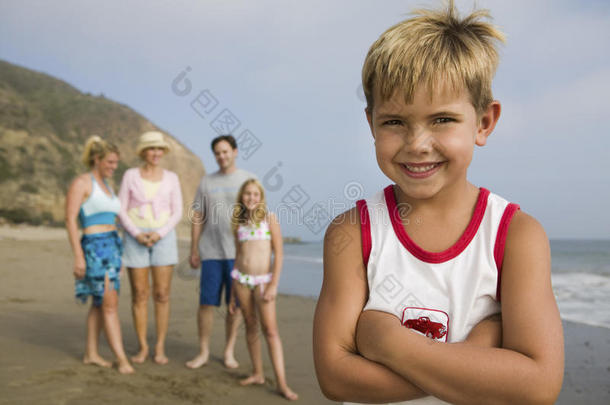 海滩上的男孩和他的家人在一起