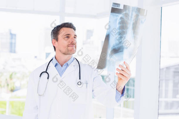严肃的男医生在检查X光片
