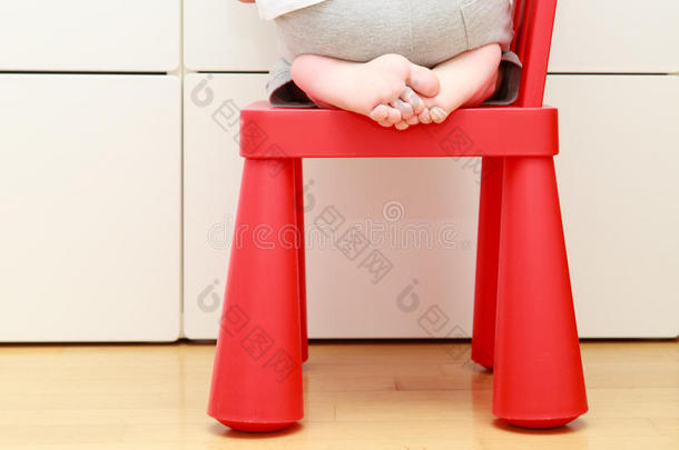 儿童脚踩婴儿椅，儿童家庭安全概念