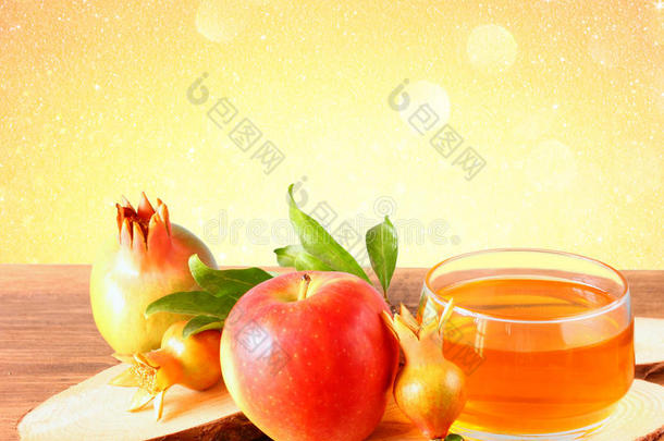 rosh hashanah概念-苹果蜂蜜和石榴放在木桌上。