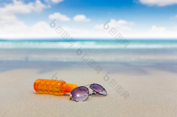 夏日海滩上的防晒霜和墨镜