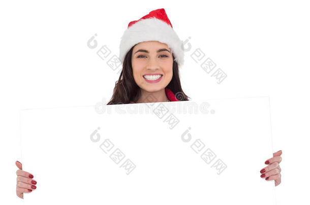带着圣诞帽的浅褐色微笑女士展示白色海报
