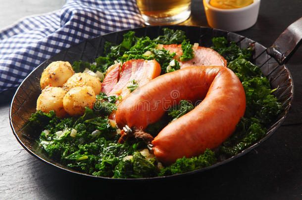 德国香肠，猪肉和土豆在蔬菜顶部