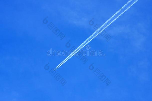 从蓝天上的飞机上留下的凝结痕迹