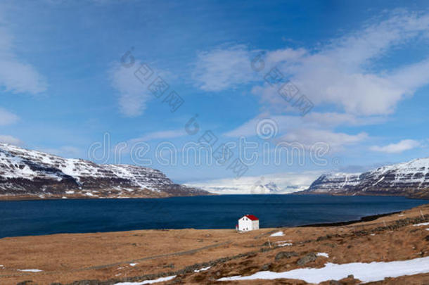 靠近湖和冰雪覆盖的冰岛西部峡湾的小屋