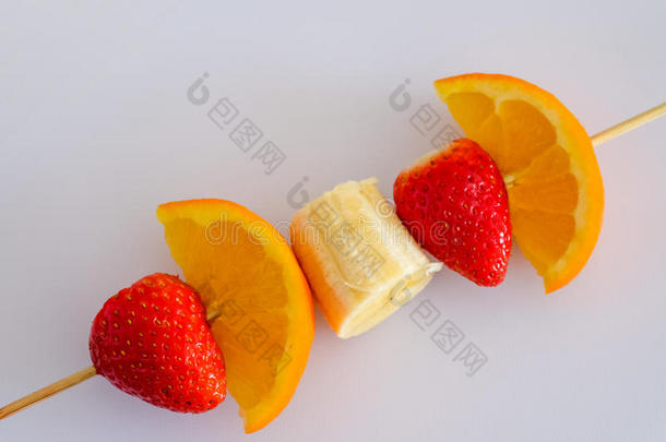 水果串与草莓，木瓜，橙色在白色背景
