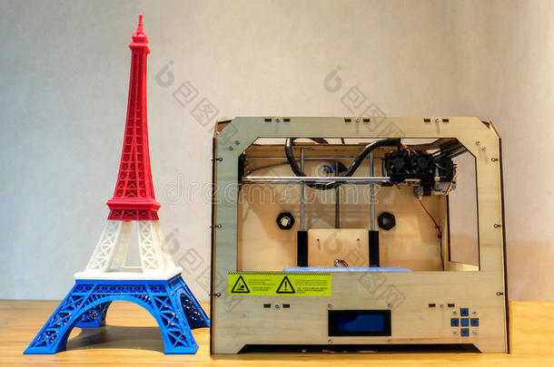 埃菲尔铁塔<strong>模型</strong>与红色白色蓝色条纹打印3D打印机与3D打印机在木桌上