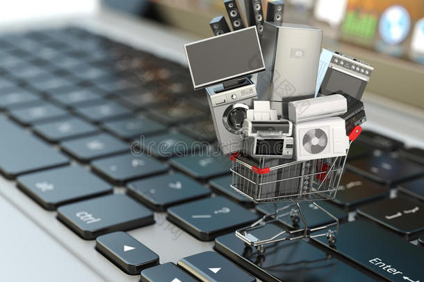 电子商务或网上购物概念。 笔记本电脑键盘上购物车中的家用电器。