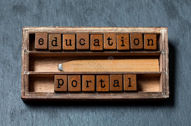 教育门户概念形象。 复古的文字块，复古风格的铅笔在木箱里。 灰色的石头背景