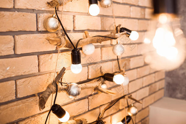 创意原创圣诞装饰。 砖墙背景的灯泡。
