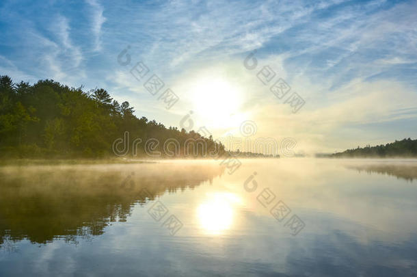 在雾蒙蒙的夏日早晨，科里湖上灿烂的日出。