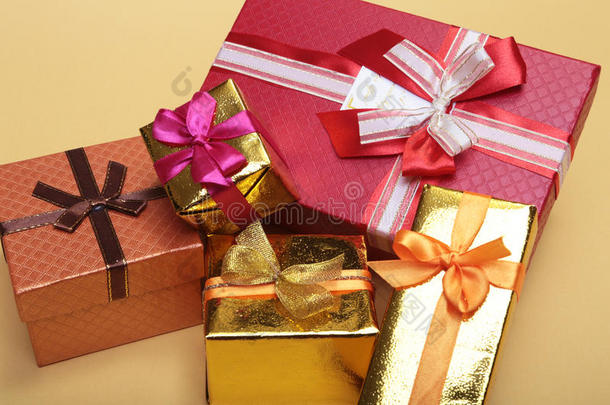 漂亮的金色礼物盒，背面有红色的蝴蝶结和丝带