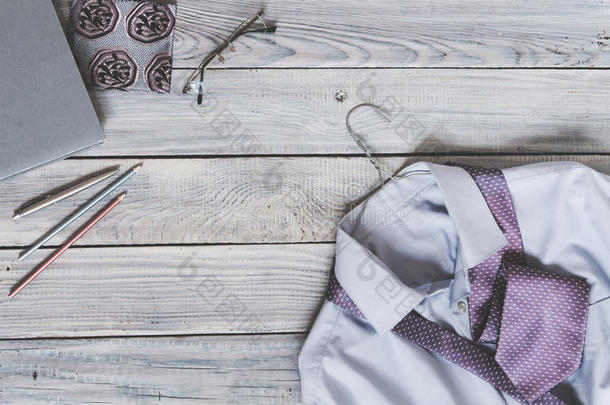 一个男人的碎片`衬衫上有一条挂在衣架上的领带和日记