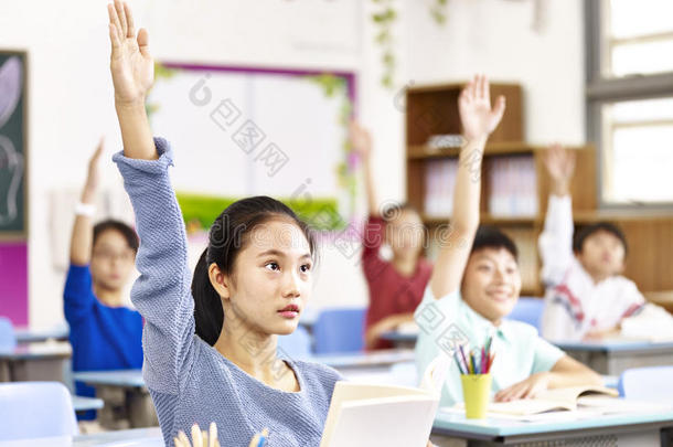 亚洲<strong>学生在教室里</strong>举手