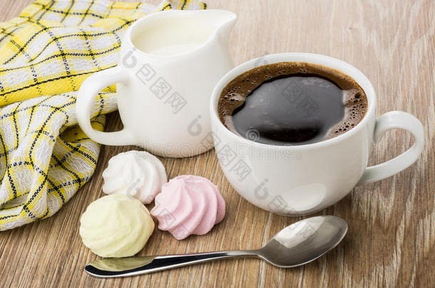 黑咖啡，奶油，水壶里的牛奶，勺子和餐巾纸