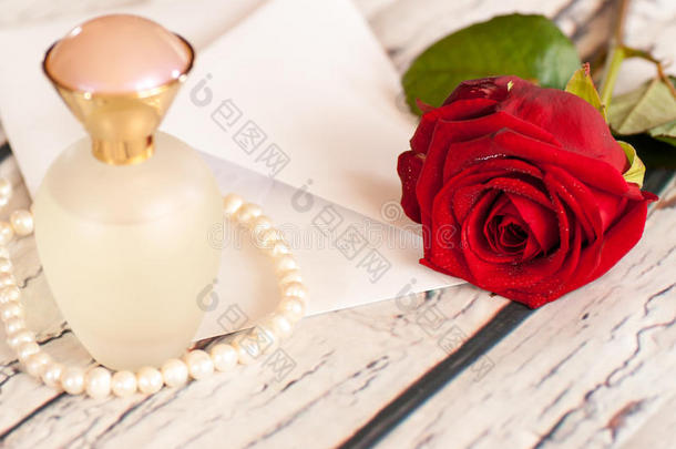 美丽的红玫瑰串珍珠香水瓶和信封爱情人节`