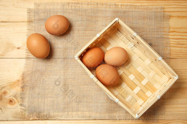 篮子里<strong>的</strong>棕色鸡蛋和家用织物紧密相连