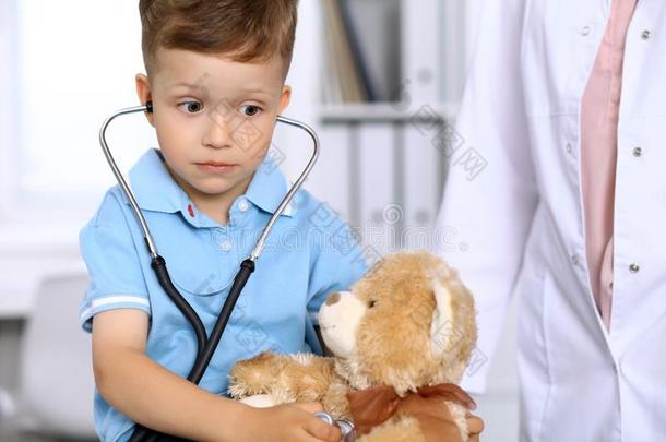 小的医生仔细检查一恩托伊be一rp一tient在旁边听诊器