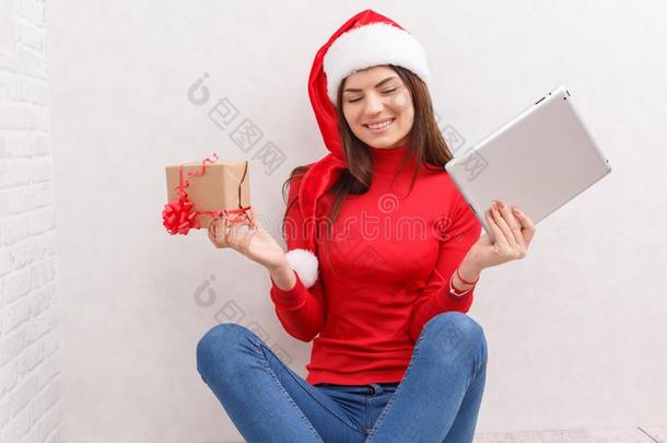 一女孩采用圣诞节衣服是（be的三单形式sitt采用g向指已提到的人地面和一t一ble