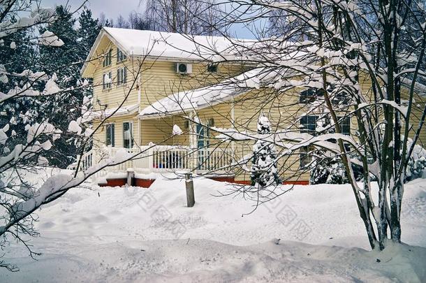 乡村房屋被环绕着的在旁边树在很大程度上大量的和雪