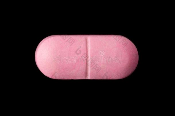 粉红色的药丸隔离的向黑的