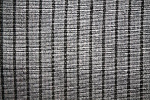 条纹关于黑的颜色向灰色织物背景.