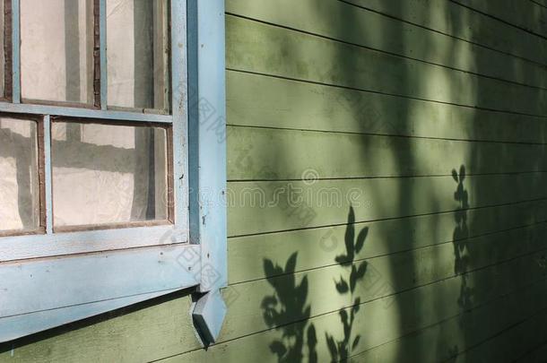 老的房屋墙和木制的窗和美丽的遮阳关于植物