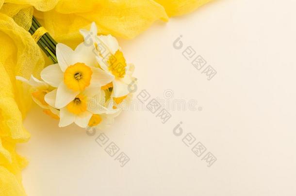 白色的水仙花花束和黄色的纺织品装饰向彩色粉笔