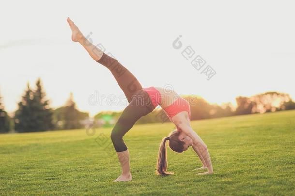 年幼的瑜伽<strong>运动鞋</strong>是（be的三单形式制造桥位置和腿在上面<strong>户外</strong>的
