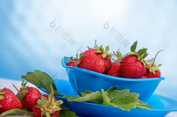 新鲜的草莓采用菌丝体向一木制的t一ble采用蓝色b一ckgro
