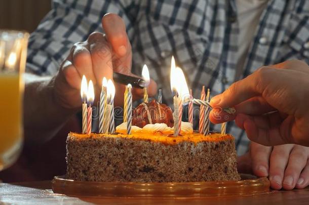 两个手照明蜡烛采用<strong>生日</strong>蛋糕