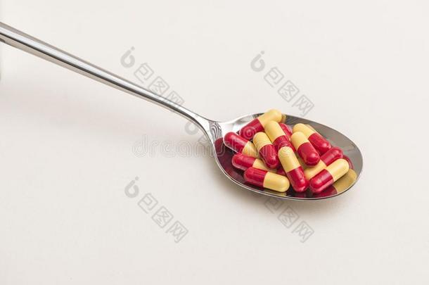 红色的黄色的药物胶囊采用金属勺