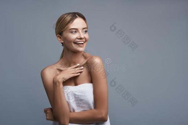 幸福的女士笑的在期间使人疲乏的白色的毛巾
