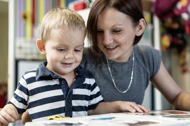 漂亮的小的男孩绘画在幼儿园.Cre在ive小孩在Playsch