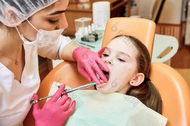 小儿科的牙医业.牙科医生款待牙关于小的女孩