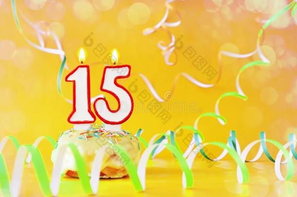 十五年生日.纸杯蛋糕和燃烧的蜡烛采用指已提到的人形状